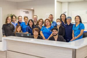 several caregivers and nurses talking at the nurse's station