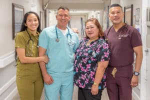 four happy nurses in the hallway at Country Hills facility
