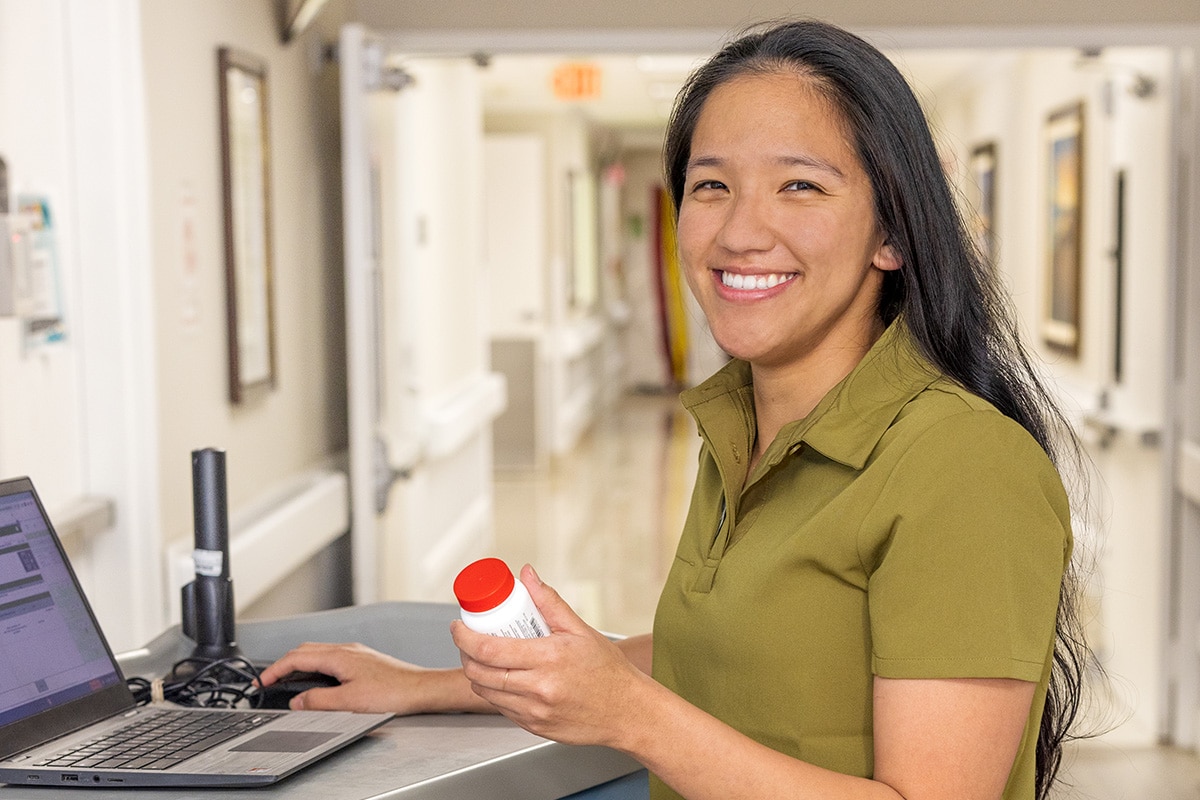 A nurse at the nurse's cart in the hallway of the Country Hills facility