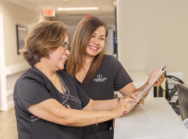 Two nurses talking at the nurse's station